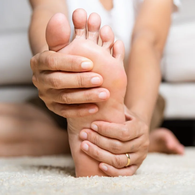 Hands cradling a foot — gentle, expert podiatry care